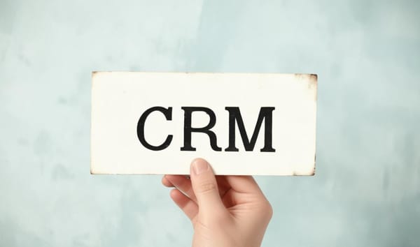 CRM이라는 단어가 쓰여진 빈티지 명함을 쥐고 있는 손. 